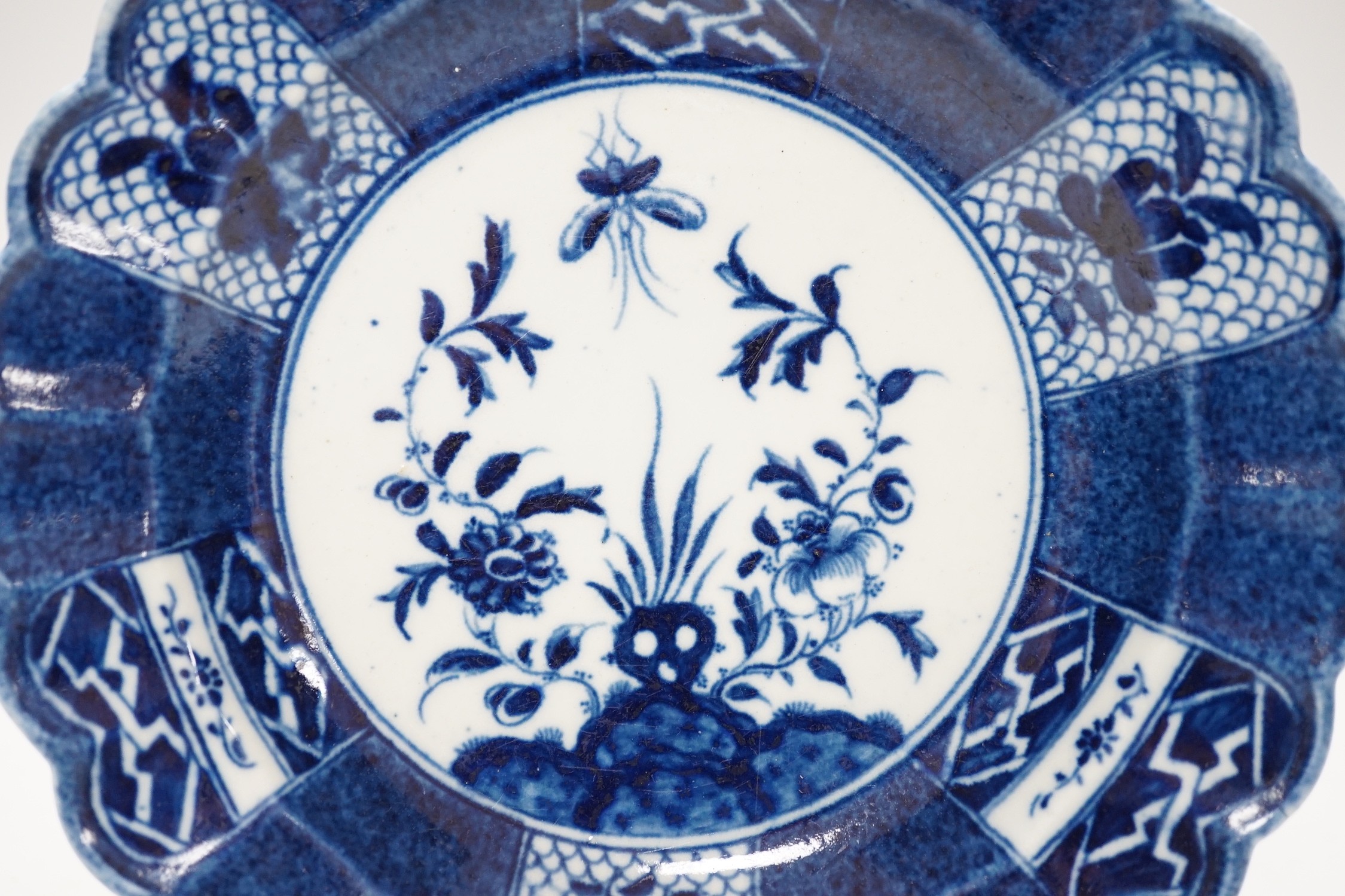 An 18th century Caughley plate painted with Scholars Rock, C mark, verso, 18cm.